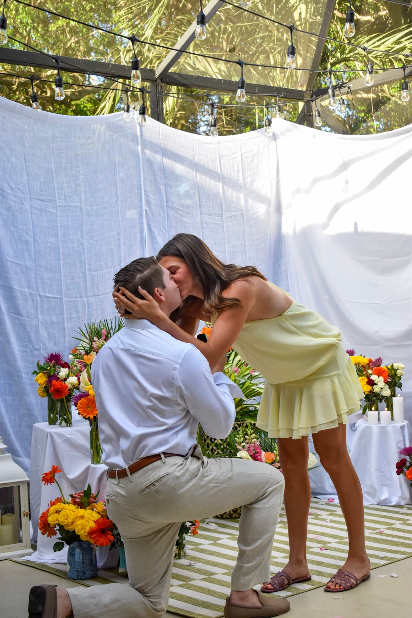 The two of them kissing under the string lights, Jon still on one knee.