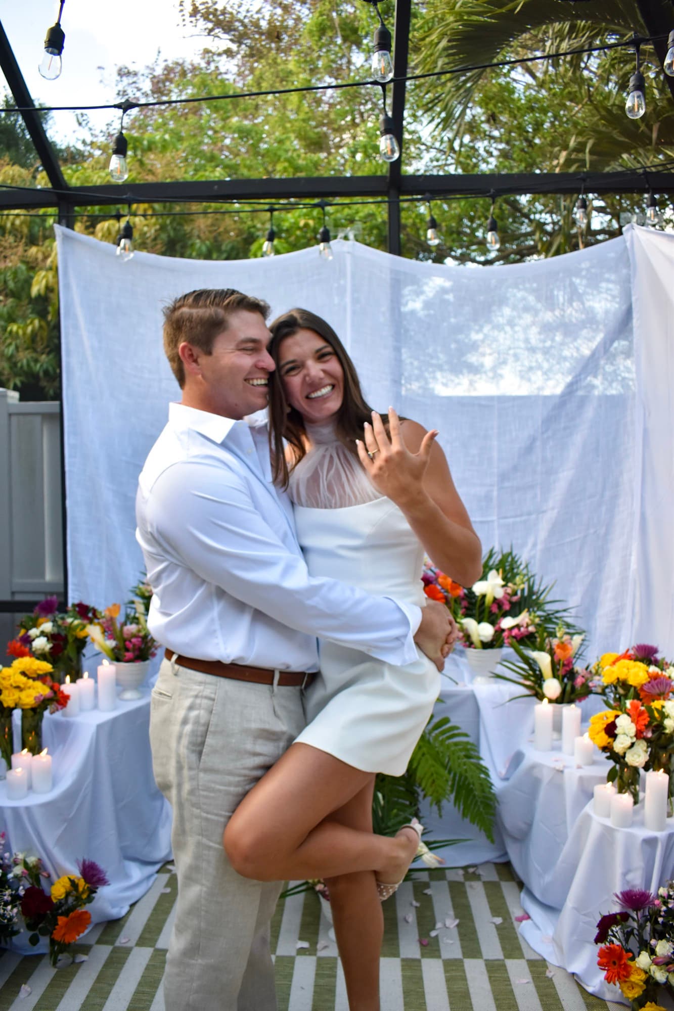 Morgan lifted off the ground, arm around Jon's neck, ring hand held out.